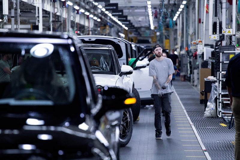 © Reuters. FILE PHOTO: Workers assemble second-generation R1 vehicles at electric auto maker Rivian's manufacturing facility in Normal, Illinois, U.S. June 21, 2024.  REUTERS/Joel Angel Juarez/File Photo