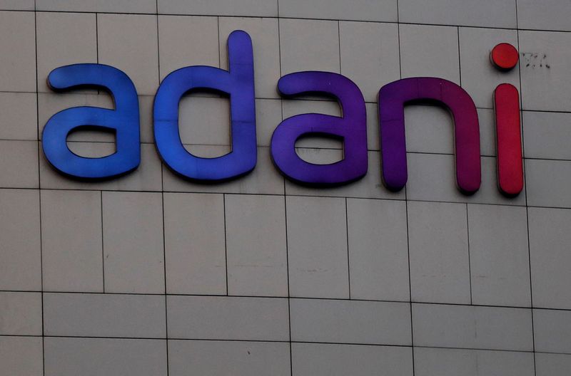 © Reuters. FILE PHOTO: The logo of the Adani Group is seen on the facade of its Corporate House on the outskirts of Ahmedabad, India, January 27, 2023. REUTERS/Amit Dave/File Photo