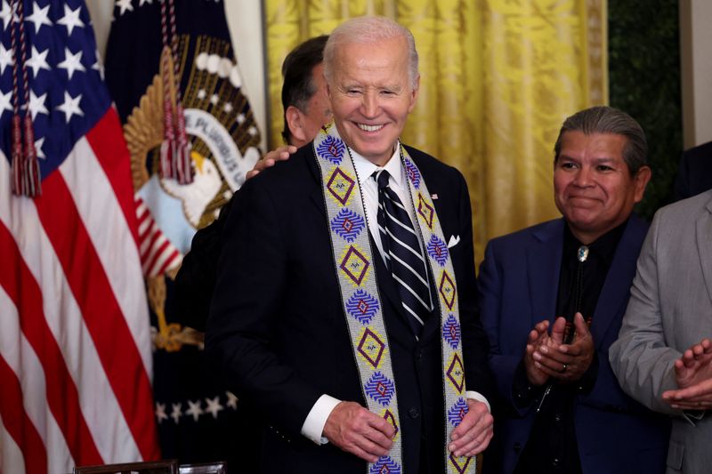 © Reuters. U.S. President Joe Biden wears a ceremonial sash as he attends an event held to establish the Chuckwalla National Monument and the Sattitla Highlands National Monument in California, at the White House in Washington, U.S., January 14, 2025. REUTERS/Kevin Lamarque